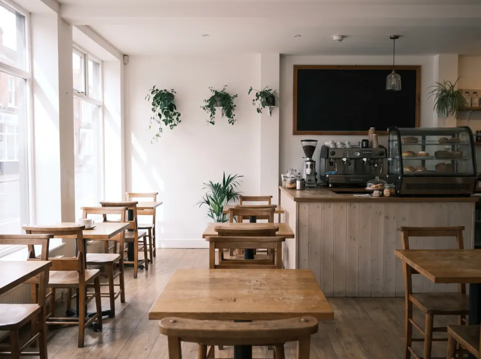 Inside the cafe, with sunlit oak tables